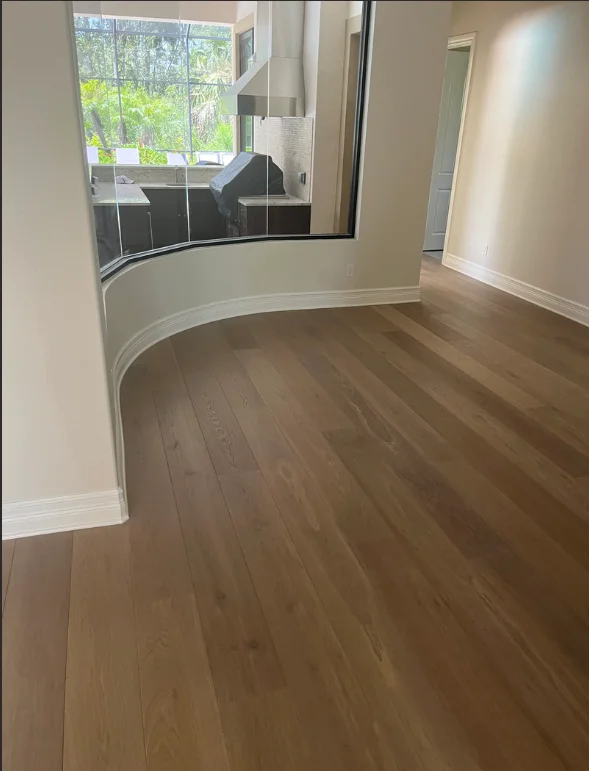 Interior room with beige painted walls, white trim, and curved architectural detail