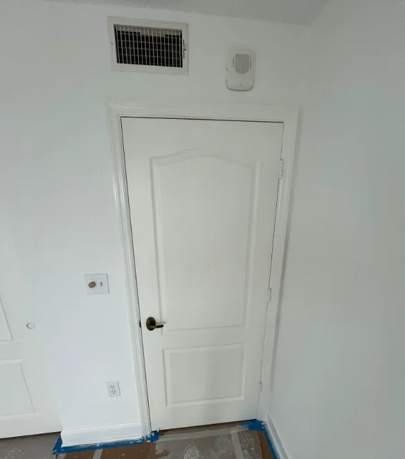White painted interior door with trim in residential space, Naples FL